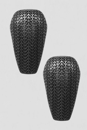 Two black elbow and knee guards with textured surface on a light gray background